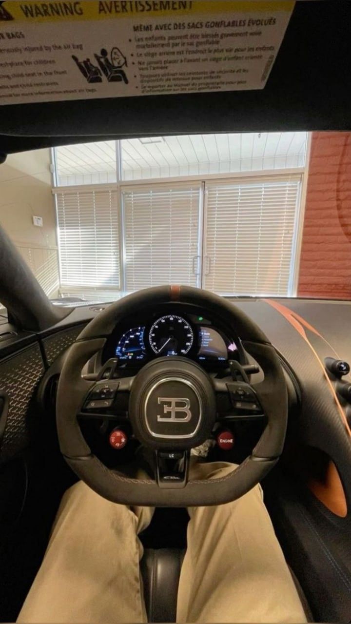 First-person view of a Bugatti steering wheel, AI swap example