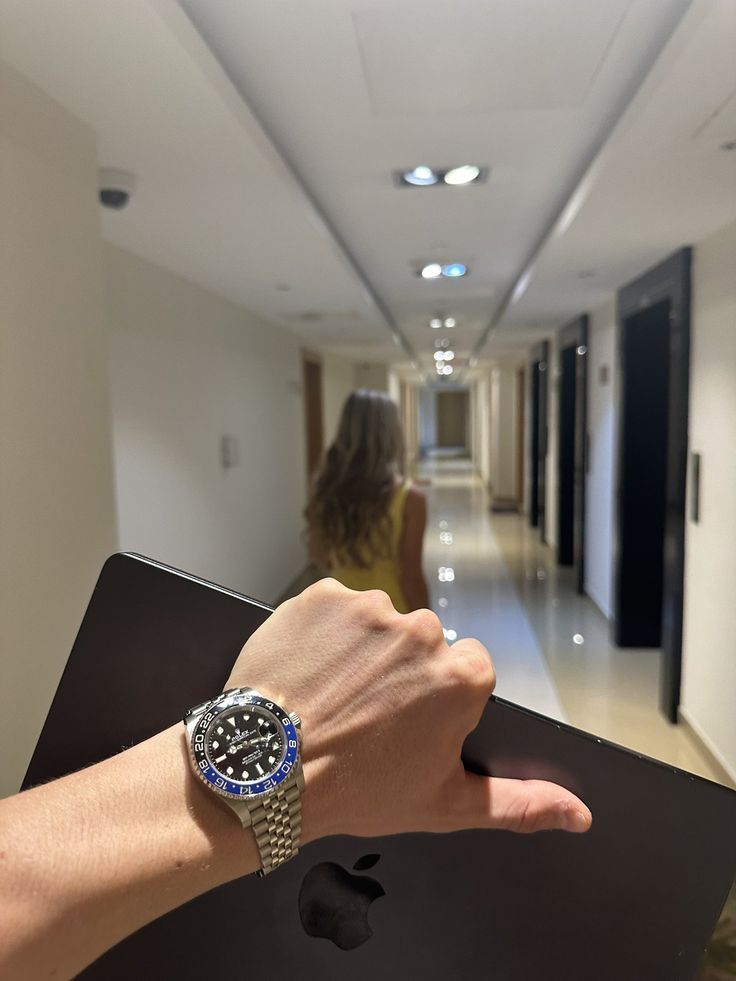 Rolex watch and MacBook in a luxury hotel hallway, AI swap example